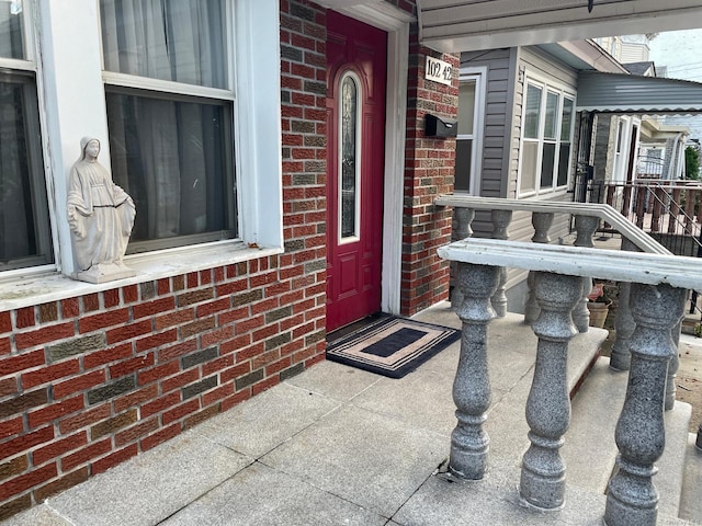 view of exterior entry with brick siding