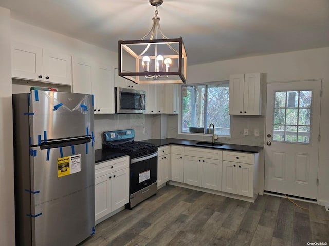 kitchen with white cabinets, plenty of natural light, sink, and stainless steel appliances