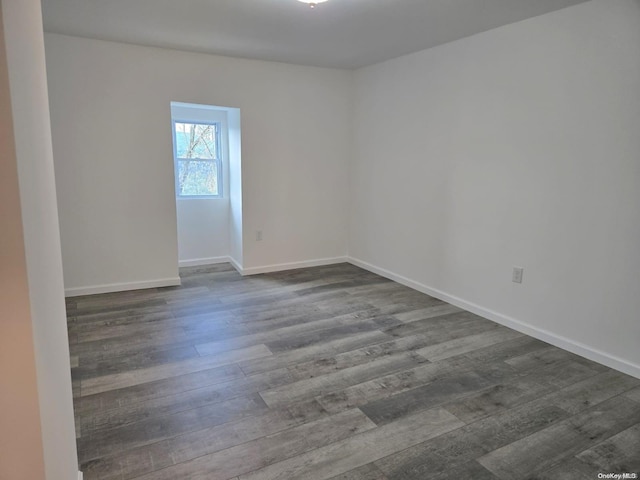 spare room featuring dark wood-type flooring