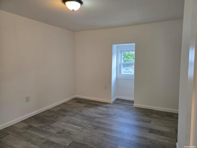 empty room with dark wood-type flooring