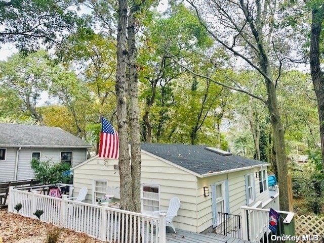 rear view of property with a wooden deck