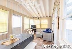 interior space featuring lofted ceiling with beams