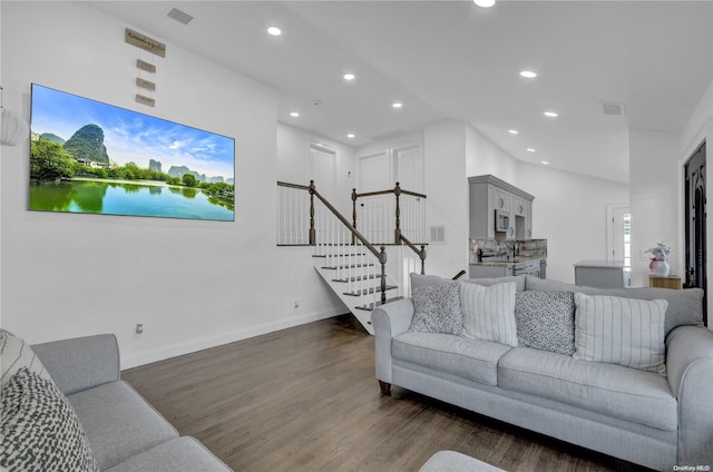 living room with dark hardwood / wood-style floors and lofted ceiling