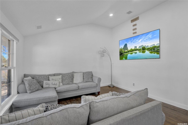 living room with dark hardwood / wood-style flooring, plenty of natural light, and lofted ceiling