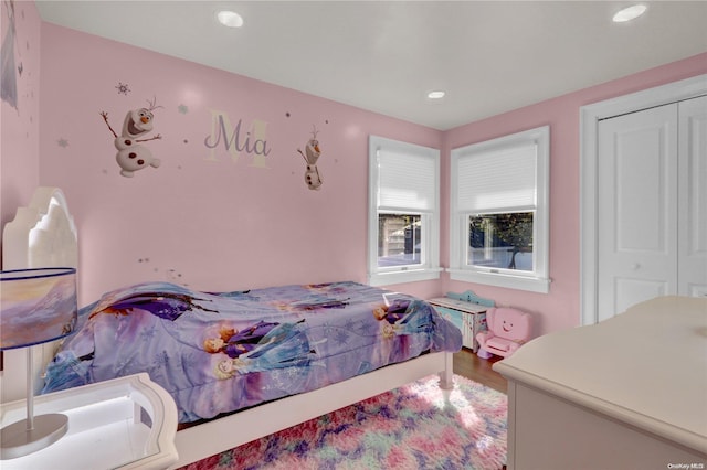 bedroom with hardwood / wood-style flooring and a closet