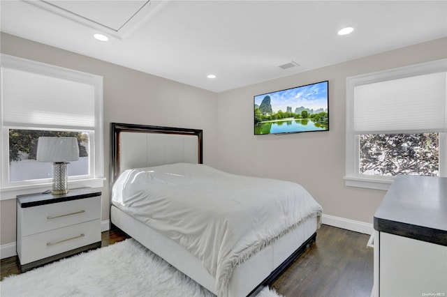 bedroom with dark hardwood / wood-style flooring