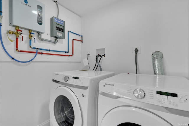 laundry area featuring washing machine and dryer and water heater