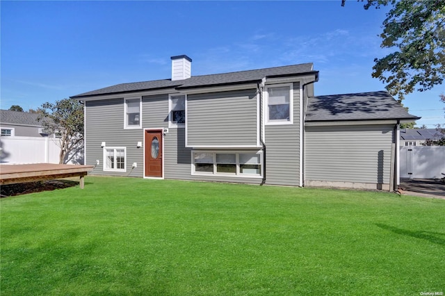 rear view of house featuring a lawn