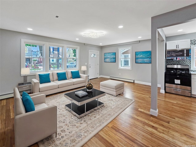 living room featuring baseboard heating and light hardwood / wood-style floors