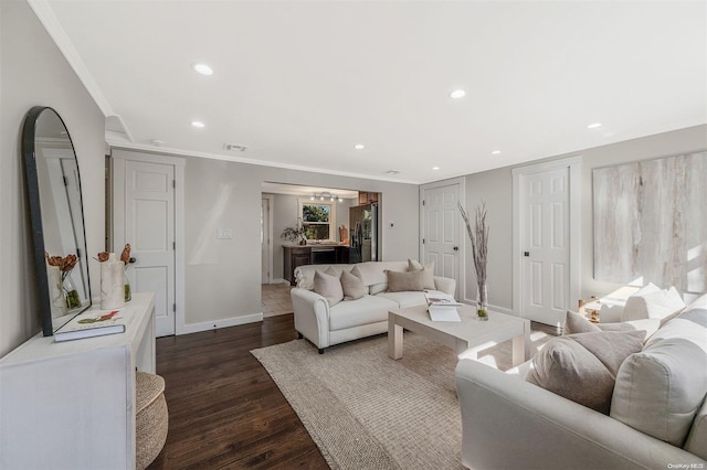 living room featuring dark wood-type flooring and ornamental molding