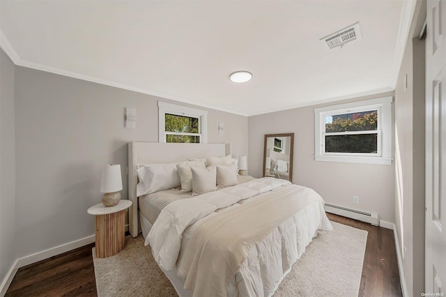 bedroom with dark hardwood / wood-style floors, baseboard heating, and ornamental molding