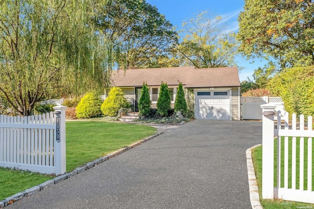 ranch-style house with a front yard and a garage