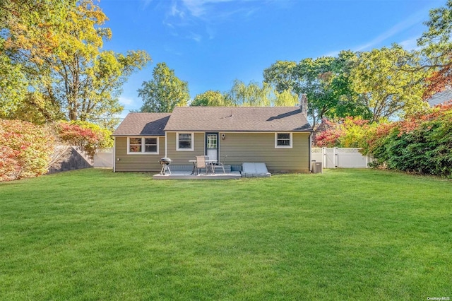 back of house featuring a patio area and a yard