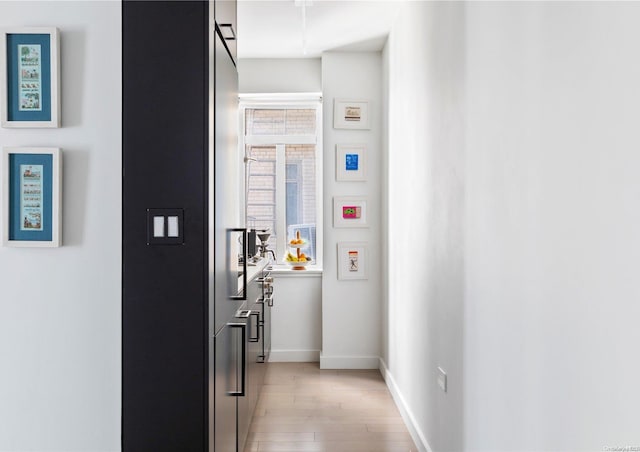 corridor with light wood-type flooring