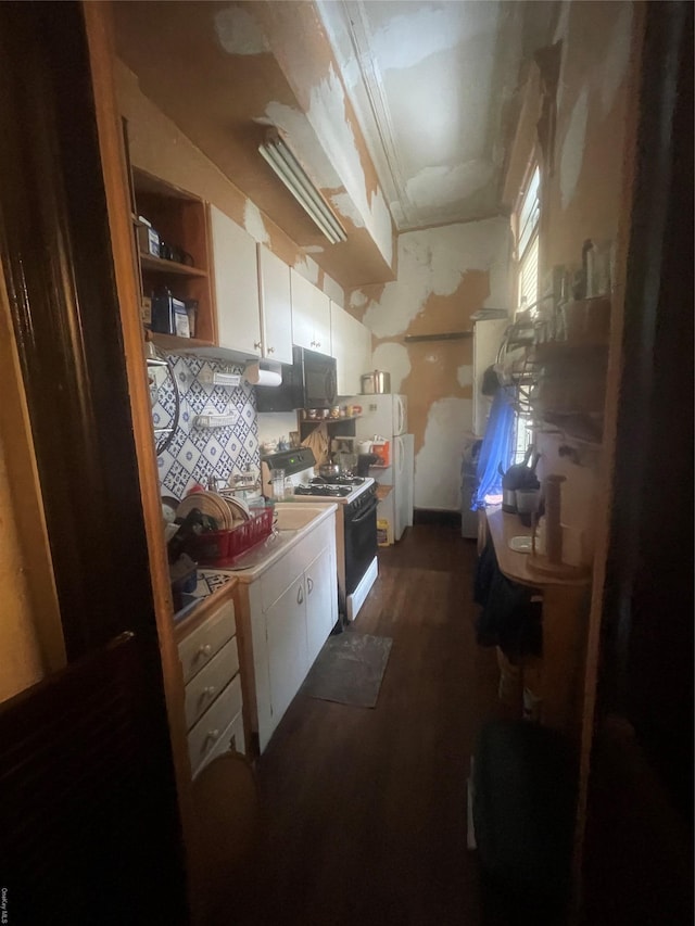 kitchen with dark hardwood / wood-style floors, white cabinets, and white appliances