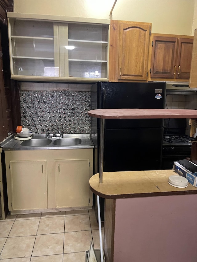 kitchen featuring tasteful backsplash and light tile patterned floors