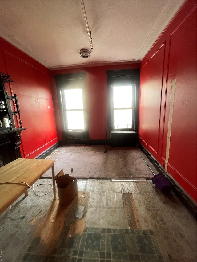 interior space with ornamental molding and a healthy amount of sunlight