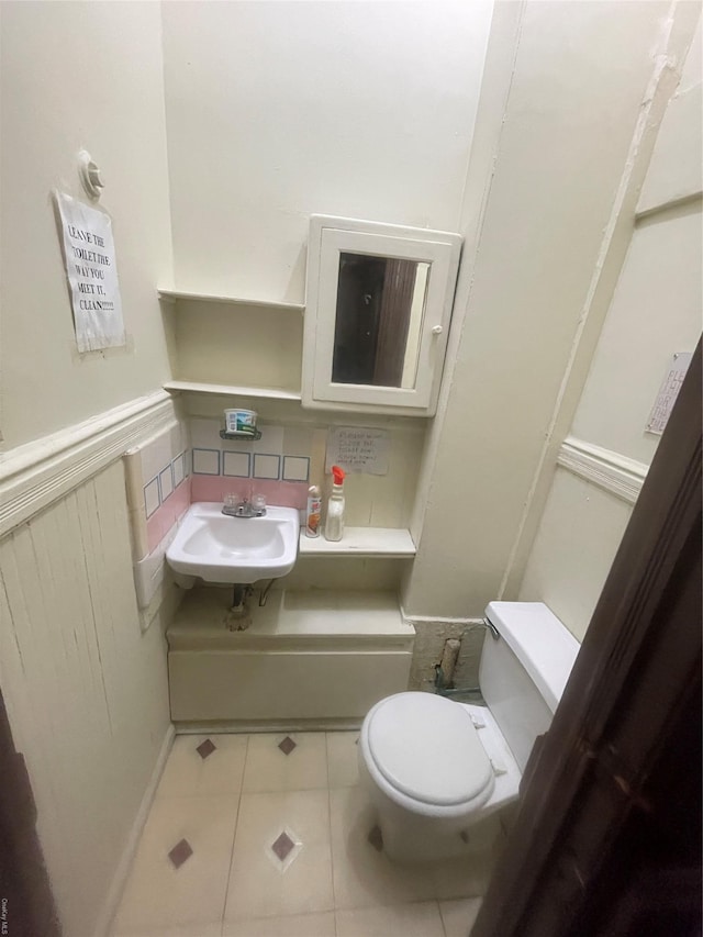 bathroom featuring sink, tile patterned floors, and toilet