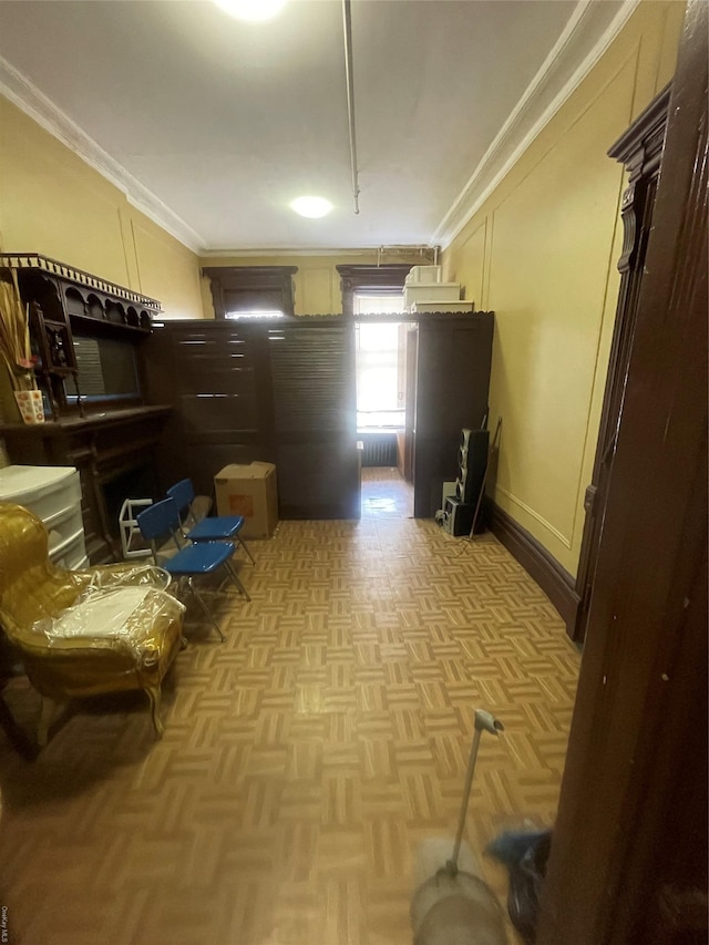 interior space featuring light parquet floors and ornamental molding