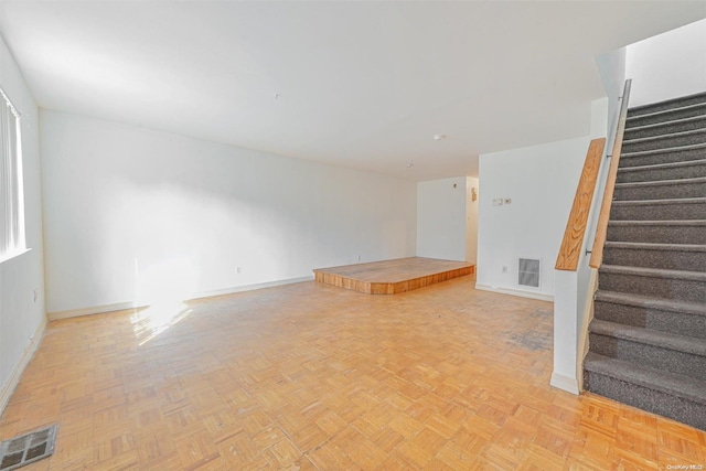 unfurnished living room with light parquet floors