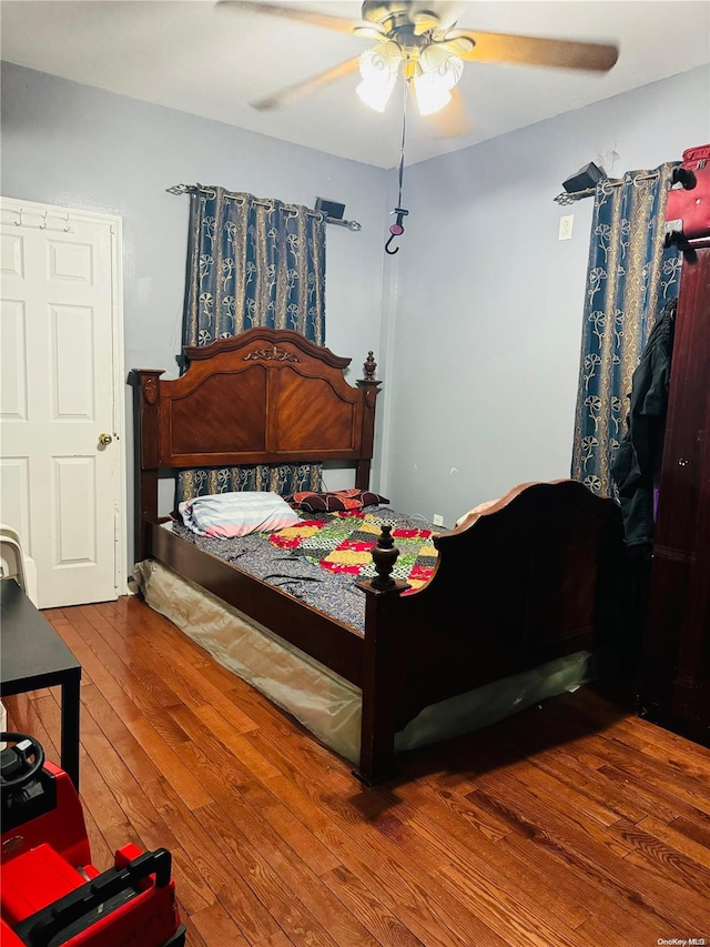 bedroom with ceiling fan and wood-type flooring