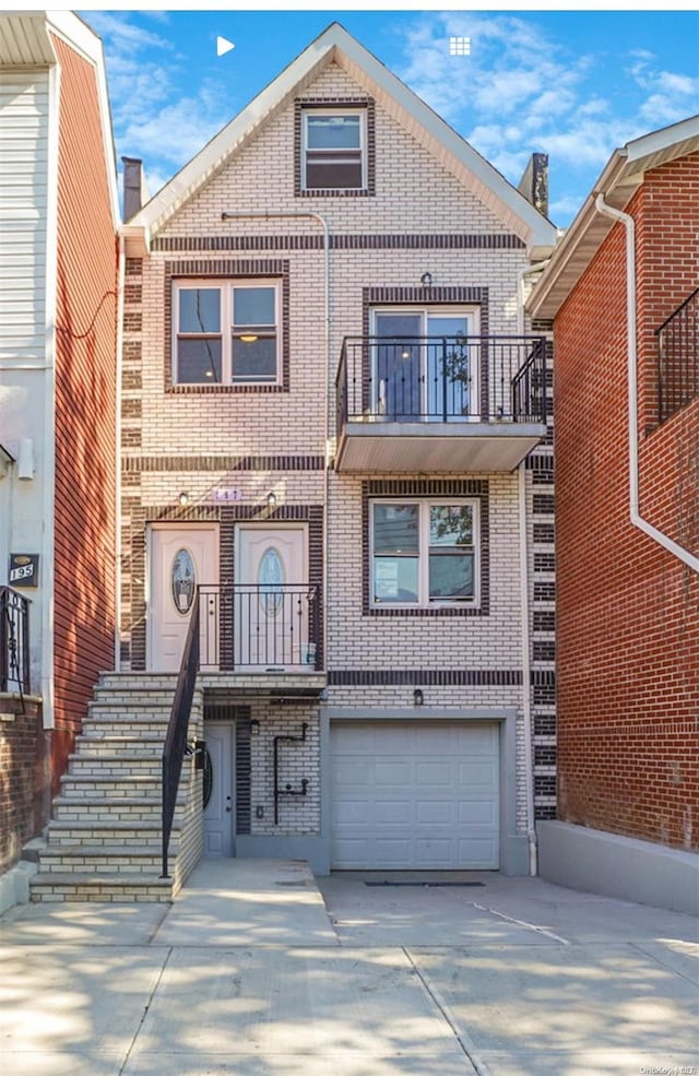 view of front of home with a balcony and a garage