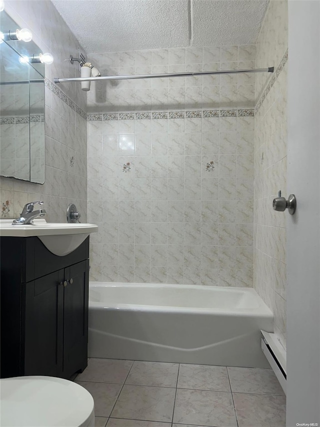 full bathroom with vanity, a textured ceiling, tile patterned floors, and tiled shower / bath