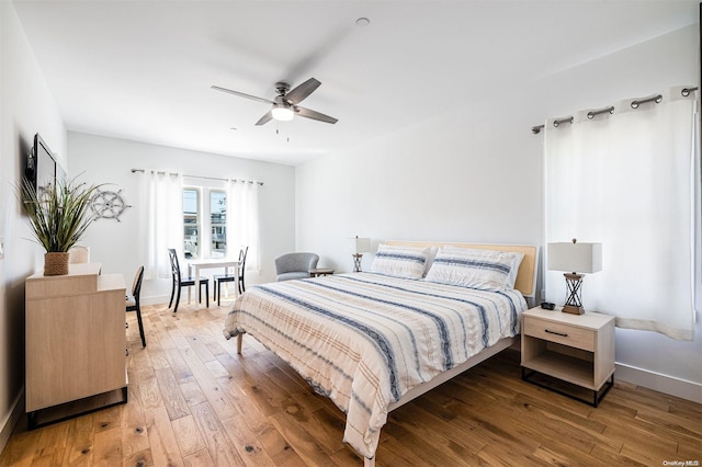 bedroom featuring hardwood / wood-style flooring and ceiling fan