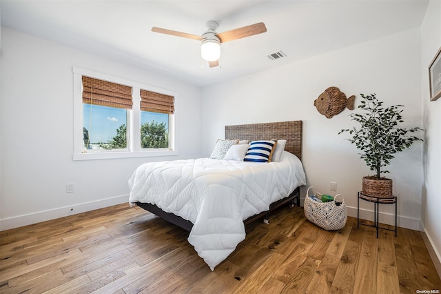 bedroom with hardwood / wood-style floors and ceiling fan