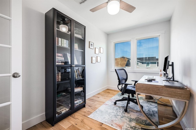 home office featuring light wood-type flooring and ceiling fan