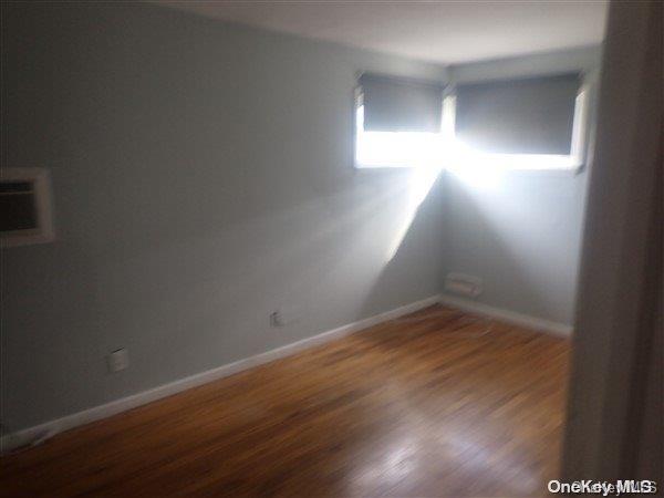 spare room with dark hardwood / wood-style floors