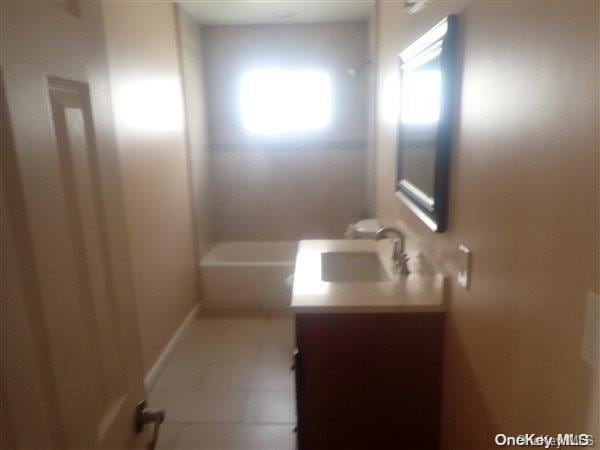 bathroom with tile patterned flooring and vanity