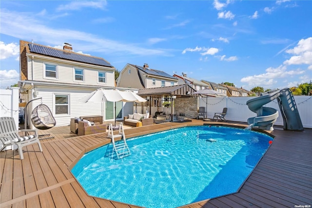 92-52 219th St, Queens Village, NY 11428 - view of swimming pool featuring an outdoor hangout area, a deck, a water slide, and a residential view