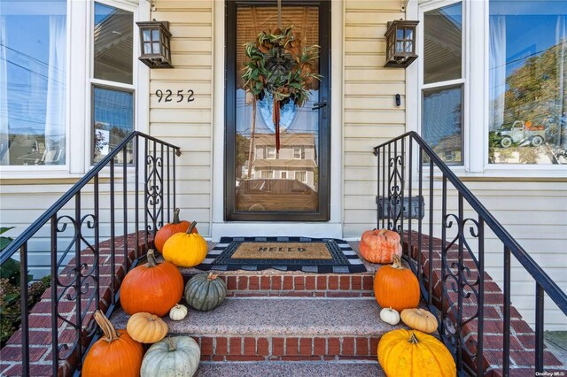 92-52 219th St, Queens Village, NY 11428 - doorway to property featuring a porch