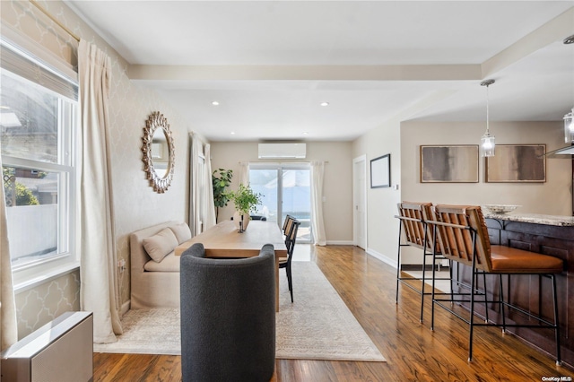 92-52 219th St, Queens Village, NY 11428 - dining area featuring a wall mounted AC, radiator heating unit, dark wood-style floors, recessed lighting, and baseboards