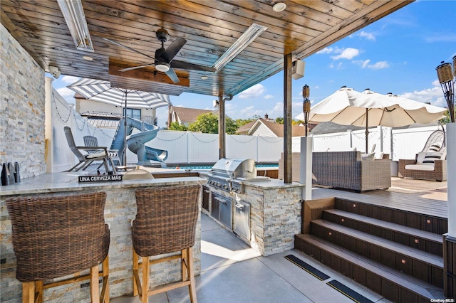 92-52 219th St, Queens Village, NY 11428 - fenced backyard with a ceiling fan, an outdoor bar, a patio area, and a wooden deck