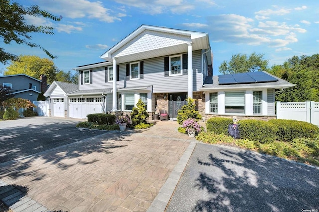 view of front of home featuring a garage and solar panels