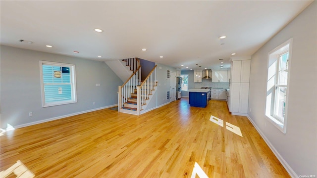 unfurnished living room with light hardwood / wood-style flooring