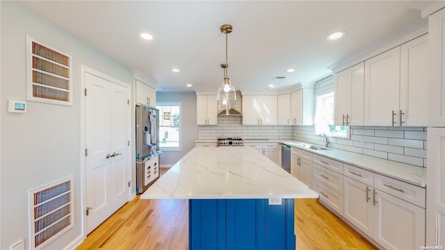 kitchen featuring light wood-type flooring, white cabinetry, and a kitchen island