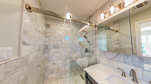 bathroom featuring vanity and an enclosed shower