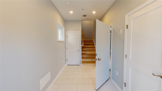 corridor featuring light tile patterned floors