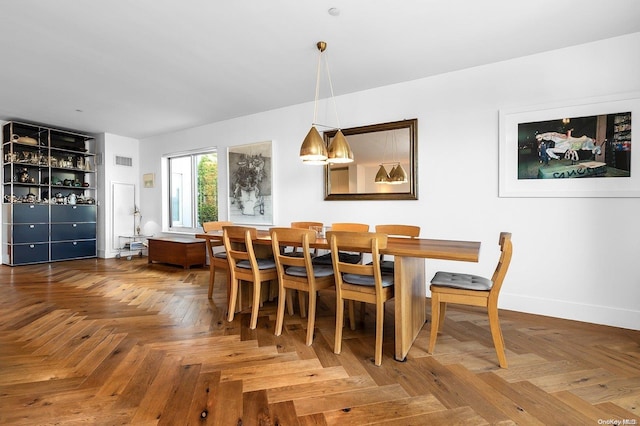 dining room with parquet flooring