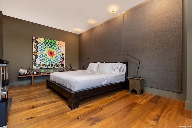 bedroom with hardwood / wood-style floors