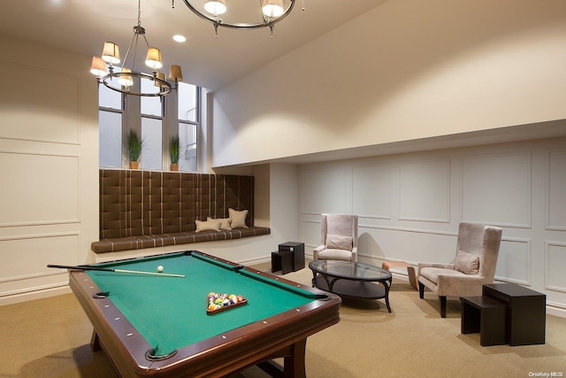 recreation room with light carpet, high vaulted ceiling, a notable chandelier, and billiards