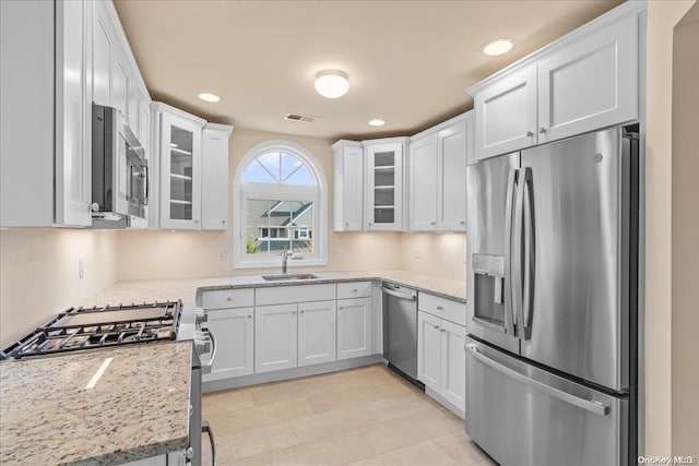 35 Steven Cir Unit 35, Dix Hills, NY 11746 - kitchen with stainless steel appliances, white cabinetry, recessed lighting, glass insert cabinets, and light stone counters