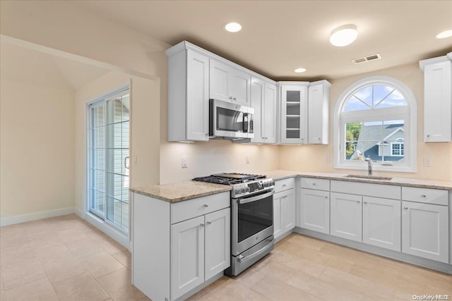 35 Steven Cir Unit 35, Dix Hills, NY 11746 - kitchen with stainless steel appliances, white cabinetry, light stone counters, glass insert cabinets, and recessed lighting