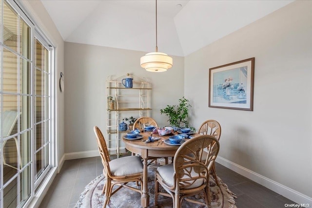 35 Steven Cir Unit 35, Dix Hills, NY 11746 - dining space featuring vaulted ceiling and dark tile patterned floors