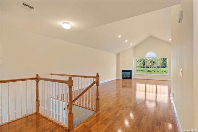 35 Steven Cir Unit 35, Dix Hills, NY 11746 - hall with wood finished floors, vaulted ceiling, and an upstairs landing