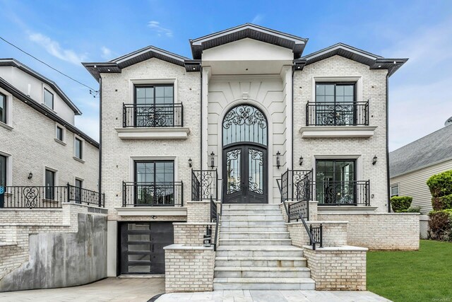 259-09 81st Ave, Glen Oaks, NY 11004 - view of front of home featuring a balcony, french doors, and brick siding