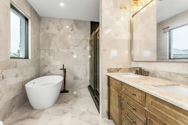 259-09 81st Ave, Glen Oaks, NY 11004 - bathroom with marble tiled floors, a shower stall, double vanity, tile walls, and a soaking tub